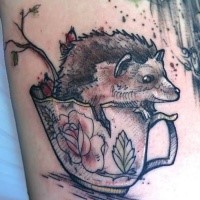 Engraving style colored tattoo of tea cup with hedgehog
