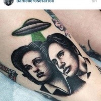 Engraving style colored thigh tattoo of humans with alien ship