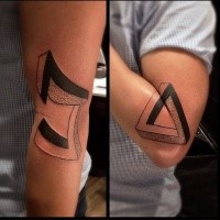 Engraving style mystical symbol tattoo on elbow