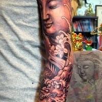 Enormous 3D style sleeve tattoo of Buddha statue with dragon and flowers