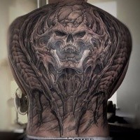 Enormous large very detailed whole back tattoo of alien skeleton