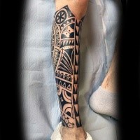 Ethnic tribal style dark black ink armor like leg detailed tattoo