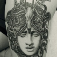 Eye blind Medusa Gorgon with animal skull on top thigh tattoo