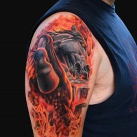 Fabulous colored shoulder tattoo of running horse in flames