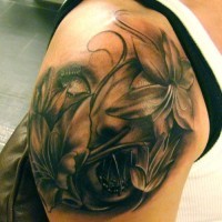 Face and flowers tattoo on arm