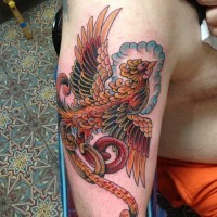 Fairy flying Phoenix bird multicolored shoulder tattoo in old school style