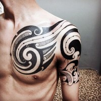 Fantastic black and white tribal tattoo on shoulder and chest