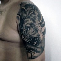Fantastic detailed black and white lion and tree shoulder zone tattoo