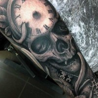 Fantastic detailed black ink skull with clock and antic key tattoo on arm