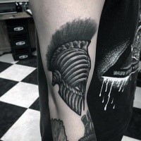 Fantastic looking black ink arm tattoo of bone helmet