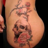 Fantastic looking colored side tattoo of human skull with blooming tree