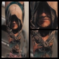 Fantastic style colored forearm tattoo of man with hood and crossed pistols