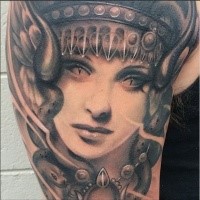 Fantasy style colored demonic woman face tattoo on shoulder