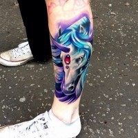 Fantasy style colored little unicorn head tattoo on leg
