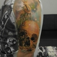 Fantasy style colored shoulder tattoo of human skull with deer