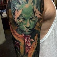 Fantasy style colored shoulder tattoo of incredible woman with flowers