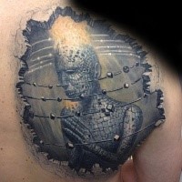 Fantasy style detailed scapular tattoo of strange looking statue with flames