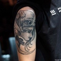 Fantasy style detailed shoulder tattoo of woman face with skull helmet