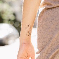 Five small arrow tattoos on girls wrist