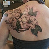 Floral style colored scapular tattoo of cool flowers