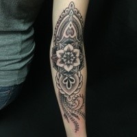 Floral tattoo painted in dotwork style on forearm