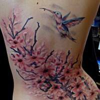 Flowering tree and a hummingbird tattoo on back