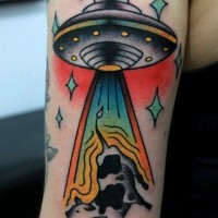 Flying ufo and cow tattoo on arm