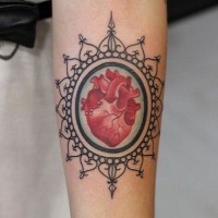 Framed red heart forearm tattoo