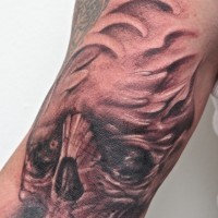 Tattoo of black monster skull