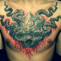 Frightful demon head tattoo on chest