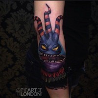 Funny 3D like colored detailed forearm tattoo of cartoon monster