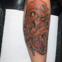 Funny cartoon like colored angry octopus tattoo on arm