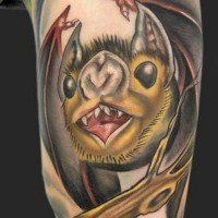 Funny cartoon like colored vampire bat tattoo on arm