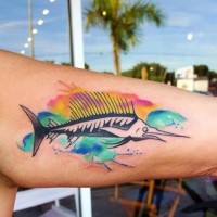 Funny cartoon like swordfish decorated with colored paint drips biceps tattoo