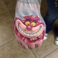 Funny cartoon smiling Cheshire cat bright colored hand tattoo