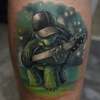 Funny cartoon turtle playing electric guitar colored tattoo on man's calf by Dmitry Varlakov