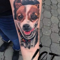 Funny colorful smiling dog portrait tattoo on arm