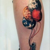 Funny designed big colored astronaut with planet shaped balloons tattoo on leg