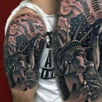 Funny designed black and white detailed statue of liberty  tattoo on shoulder with microphone