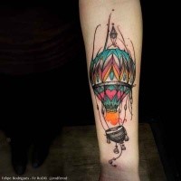 Funny illustrative style colored forearm tattoo of flying balloon