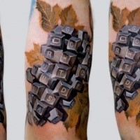 Funny looking colored arm tattoo of plant made from keyboard keys