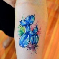 Funny looking colored balloon dog tattoo on forearm