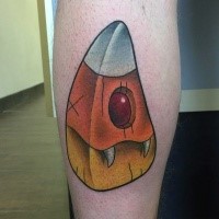 Funny looking colored leg tattoo of monster statue with vampire teeth