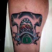 Funny looking colored leg tattoo of shark stylized with number and sailing ship