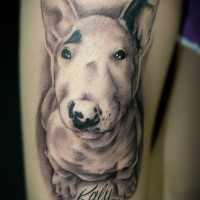 Funny looking cute thigh tattoo of dog with lettering