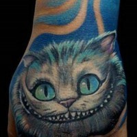 Funny looking detailed and colored hand tattoo of Cheshire cat face