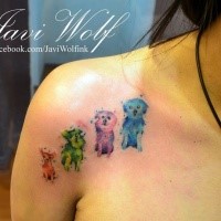 Funny looking watercolor style small puppies tattoo on shoulder