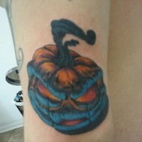 Funny monster like colored little pumpkin tattoo on arm