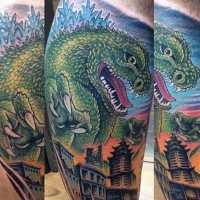 Funny painted colored big Godzilla with city tattoo on leg
