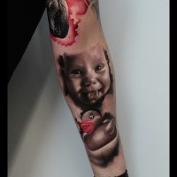 Funny portrait style colored forearm tattoo of smiling boy with duck